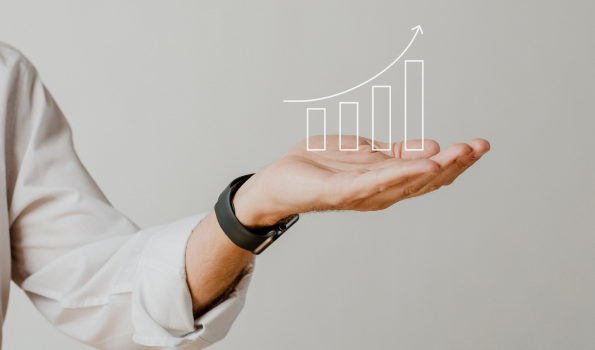 digital-increasing-bar-graph-with-businessman-hand-overlay 1